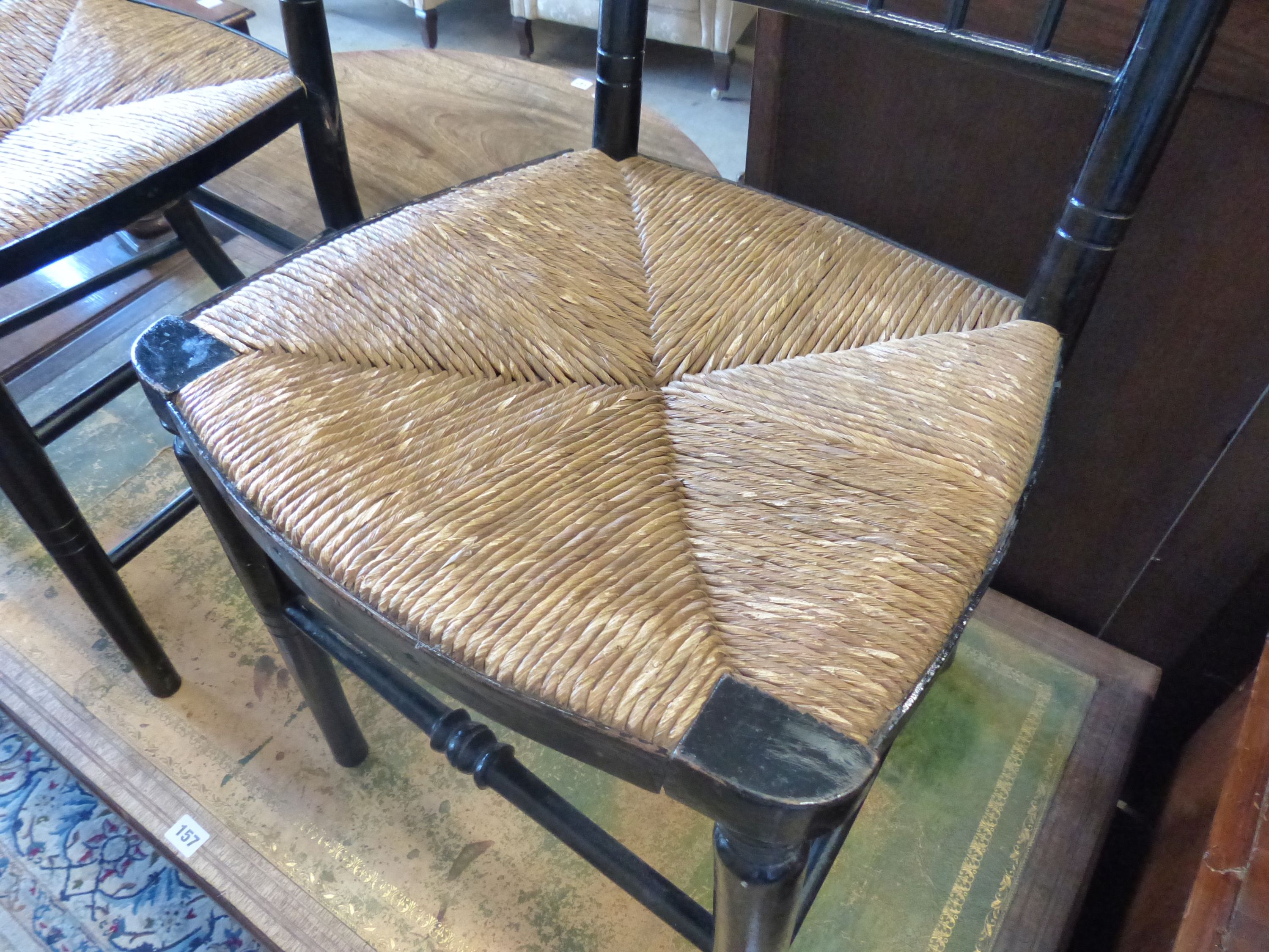 A pair of 19th century Sussex type ebonised rush seat chairs